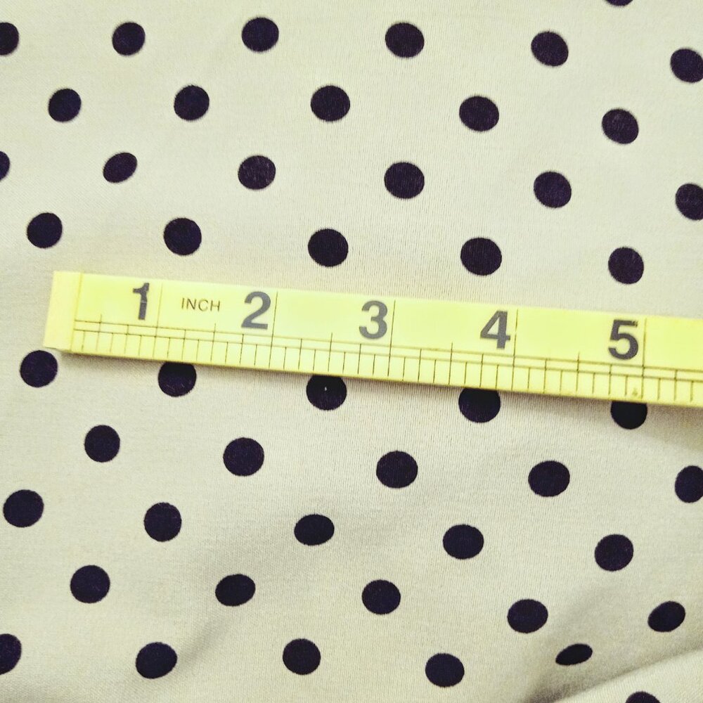 1 yard of beige and black polka dot fabric
